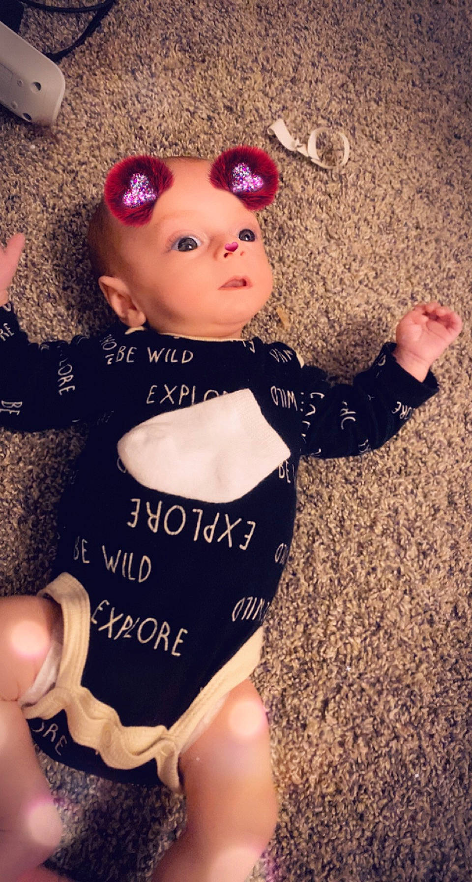 Emerson is registered to the contest to win money with this photo: baby_toddler_clothing, chest, doll, fashion_accessory, finger, gesture, happy, human_body, joint, magenta, nail, pattern, person, pink, sleeve, thigh, thumb, toy, waist, white