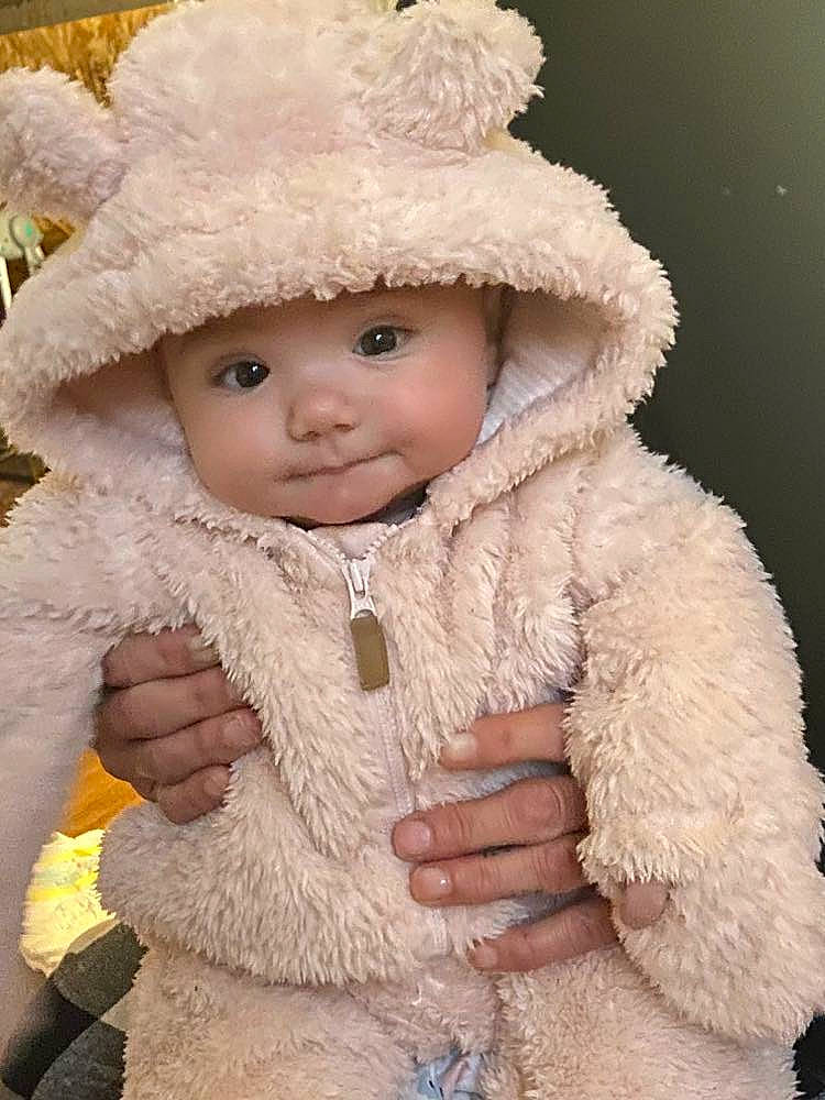 Everlee is registered to the contest to win money with this photo: baby, baby_toddler_clothing, cap, cheek, eye, face, fur, fur_clothing, gesture, happy, head, headwear, iris, jacket, nose, outerwear, person, skin, sleeve, toddler