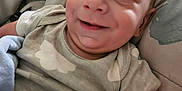 Ian is registered to the contest to win money with this photo: baby, infant, smiling, face, onesie, cloud_pattern, blanket, blue_blanket, bed, bedding, cozy, child, cute, happy, person, indoors, portrait, newborn, head, skin