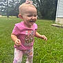 child, toddler, baby, pink_shirt, floral_pants, hair_bow, grass, lawn, outdoors, smiling, laughing, candid, portrait, walking, person, trees, house, casual_clothing, happy, daytime
