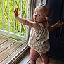 baby, toddler, child, standing, barefoot, hair_bow, sundress, window, glass, porch, railing, lawn, wooden_floor, door, looking_back, curious, portrait, hand, face, balcony