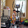 Gael joined the competition — help win amazing prizes! child, toddler, elliptical_machine, toy_car, toys, indoor, window, curtains, flooring, exercise_equipment, playroom, barefoot, striped_clothing, cabinet, air_conditioner, plastic_toys, colorful, home_interior, wood_floor, curtained_window