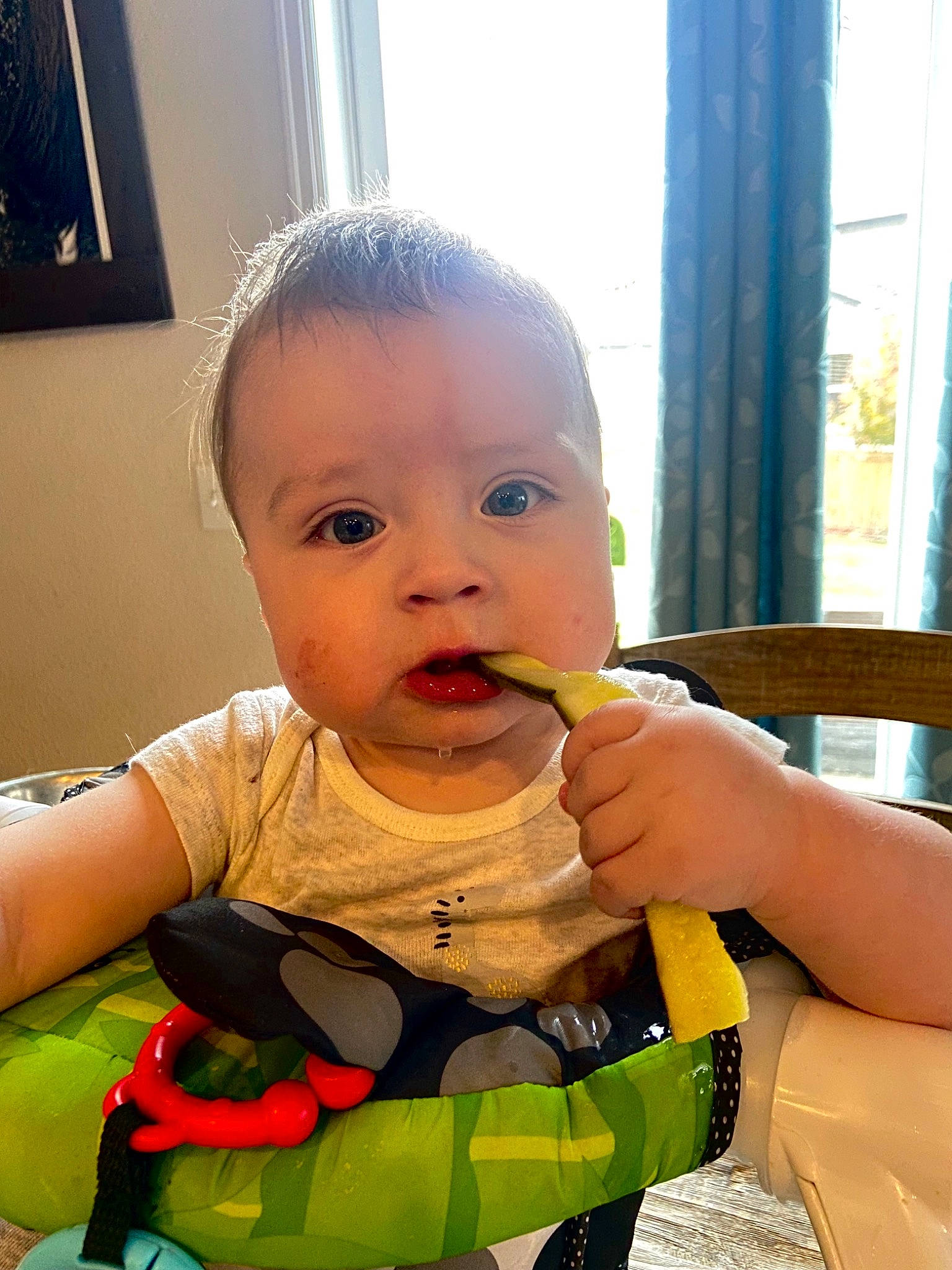 Desmond is registered to the contest to win money with this photo: baby, baby_grabbing_for_something, baby_playing_with_toys, baby_toddler_clothing, blue, cheek, child, curtain, facial_expression, finger, fun, hairstyle, happy, mouth, nose, person, picture_frame, skin, thumb, toddler