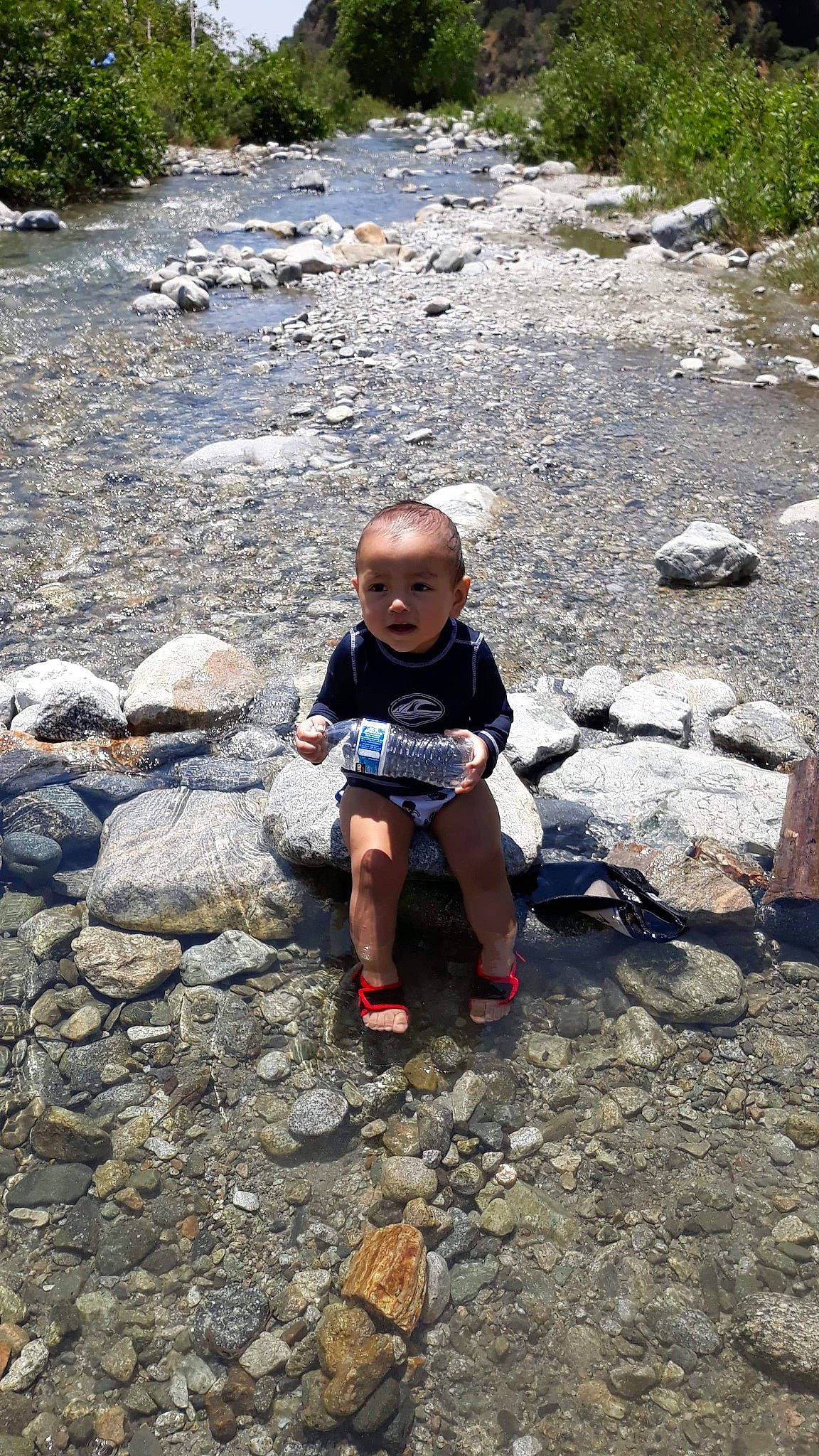 Melvyn is registered to the contest to win money with this photo: adventure, bedrock, child, fun, geological_phenomenon, leisure, person, recreation, rock, stream, stream_bed, toddler, vacation, water, watercourse