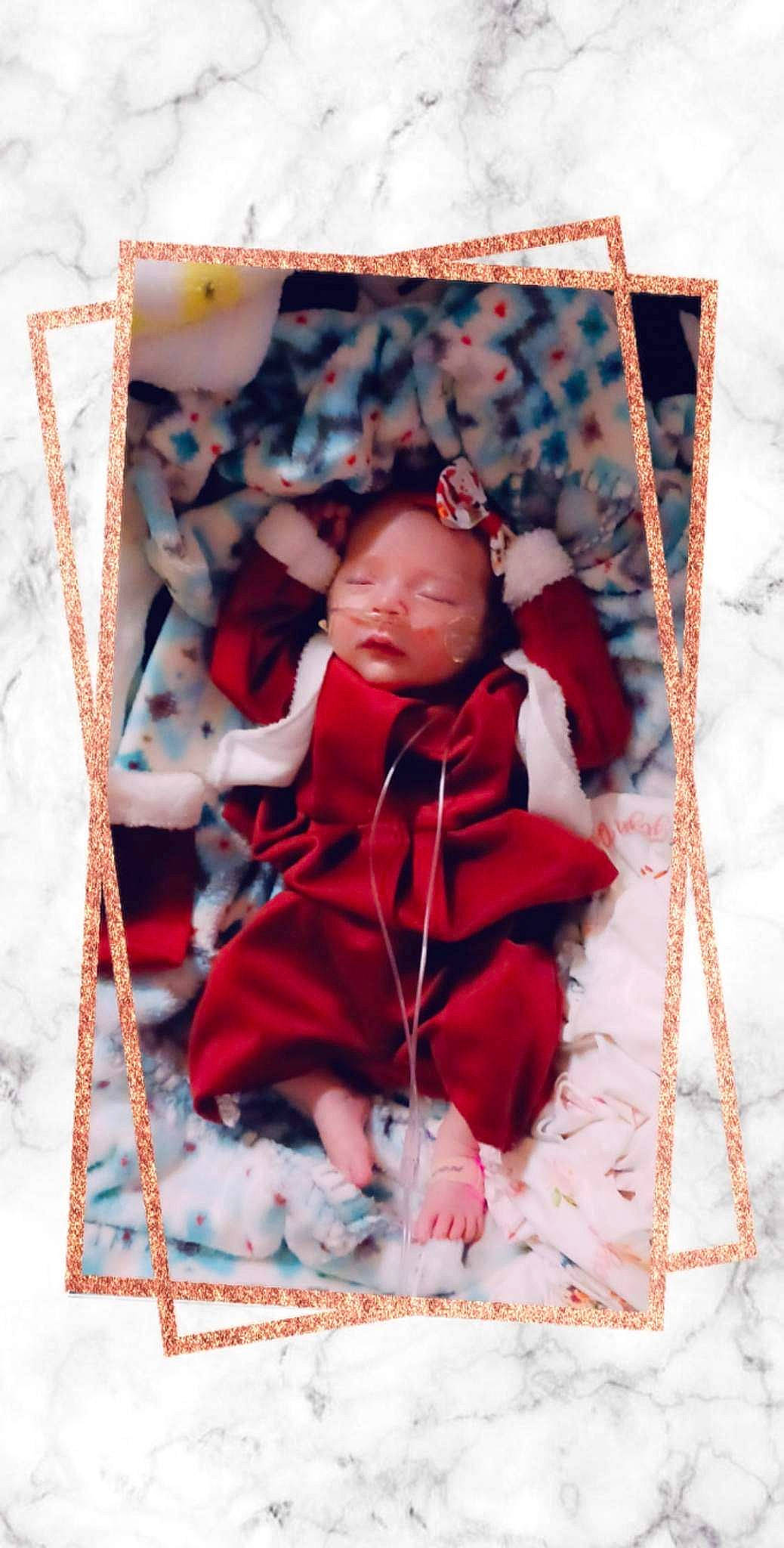 Kaylyn is registered to the contest to win money with this photo: baby, baby_products, baby_toddler_clothing, bedding, child, comfort, happy, linens, magenta, pattern, person, picture_frame, rectangle, room, sleeve, t_shirt, textile, toddler, winter, wood