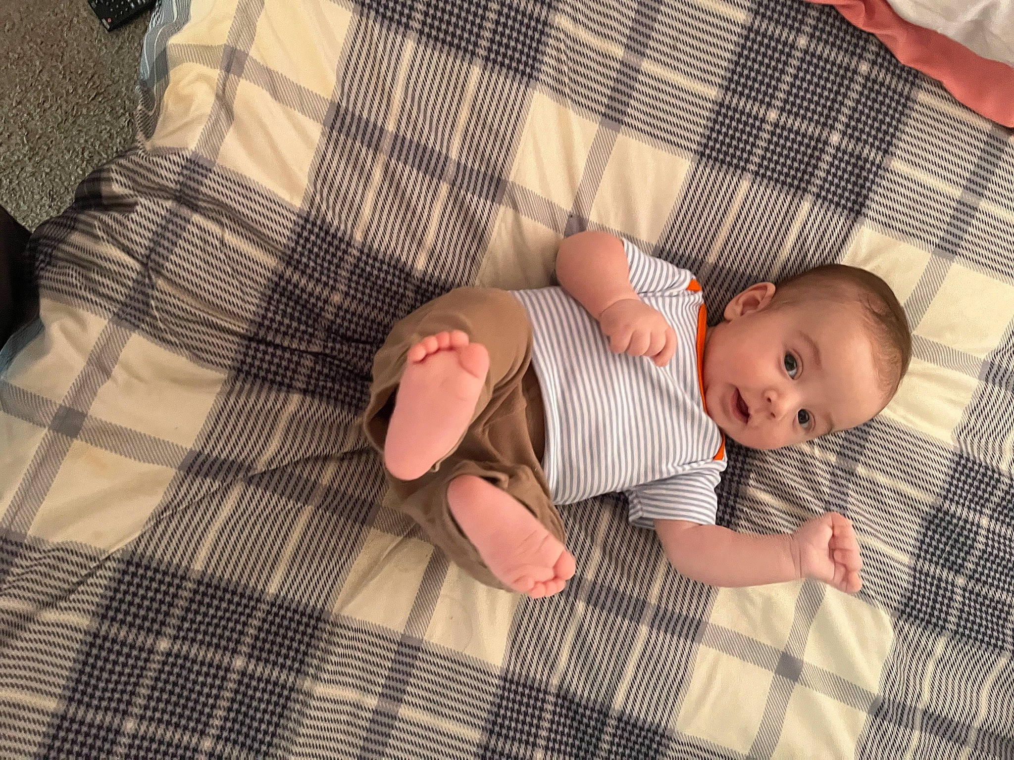 Brody is registered to the contest to win money with this photo: baby, baby_toddler_clothing, child, comfort, dress, finger, foot, hand, human_body, leg, linens, nail, pattern, person, plaid, skin, sleeve, sock, tartan, toddler
