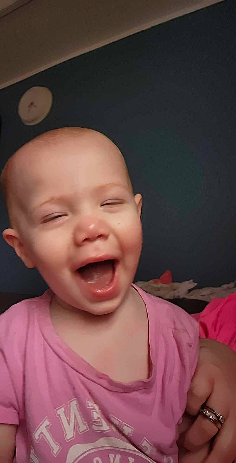 Renesmee is registered to the contest to win money with this photo: baby, baby_laughing, cheek, chin, ear, eye, eyebrow, gesture, happy, head, jaw, lip, mouth, nose, person, pink, skin, smile, toddler, tongue