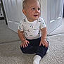 baby, child, smiling, sitting, carpet, white_shirt, navy_pants, sock, indoor, home, door, floor, cute, happy, portrait, toddler, person, clothing, skin, face