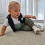 Matteo joined the competition — help win amazing prizes! toddler, child, carpet, indoor, casual_clothing, white_shirt, vest, sneakers, curious, baby, person, floor, home, candid, young_child, exploring, light, expression, cute, comfortable