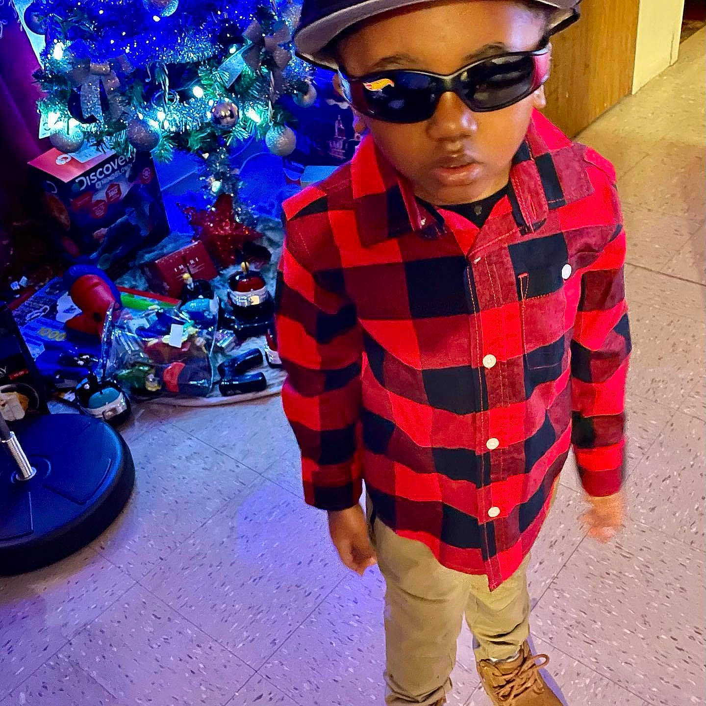 Quamieke Kotto Harris is registered to the contest to win money with this photo: blue, cap, christmas_tree, cool, electric_blue, entertainment, eyewear, fashion_design, glasses, goggles, head, light, magenta, person, personal_protective_equipment, pink, sleeve, street_fashion, sunglasses, toddler