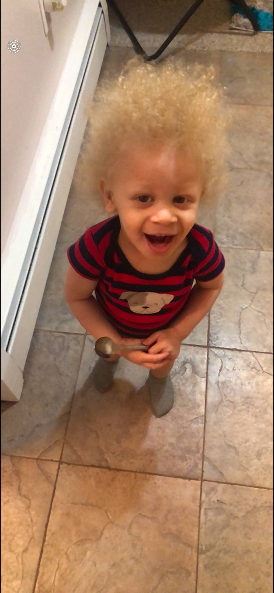 Lucci is registered to the contest to win money with this photo: baby, baby_toddler_clothing, cheek, child, facial_expression, floor, flooring, foot, fun, glasses, happy, line, mouth, nose, person, sitting, skin, smile, standing, toddler