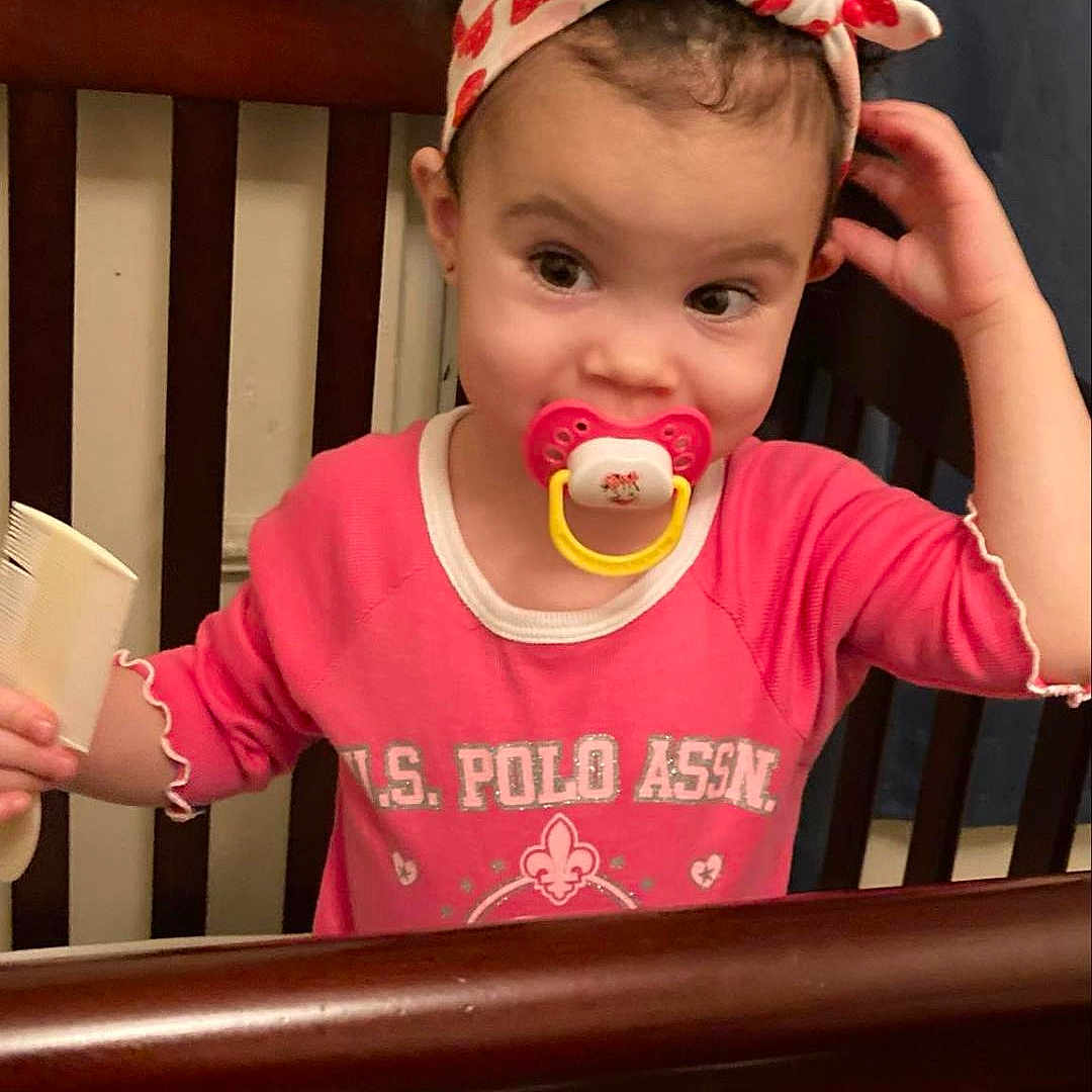 Xyla Wheeland is registered to the contest to win money with this photo: accessories, baby, bed, beverage, clothing, coffee, coffeecup, couch, crib, cutlery, face, furniture, head, indoors, infantbed, person, photography, portrait, spoon, t_shirt