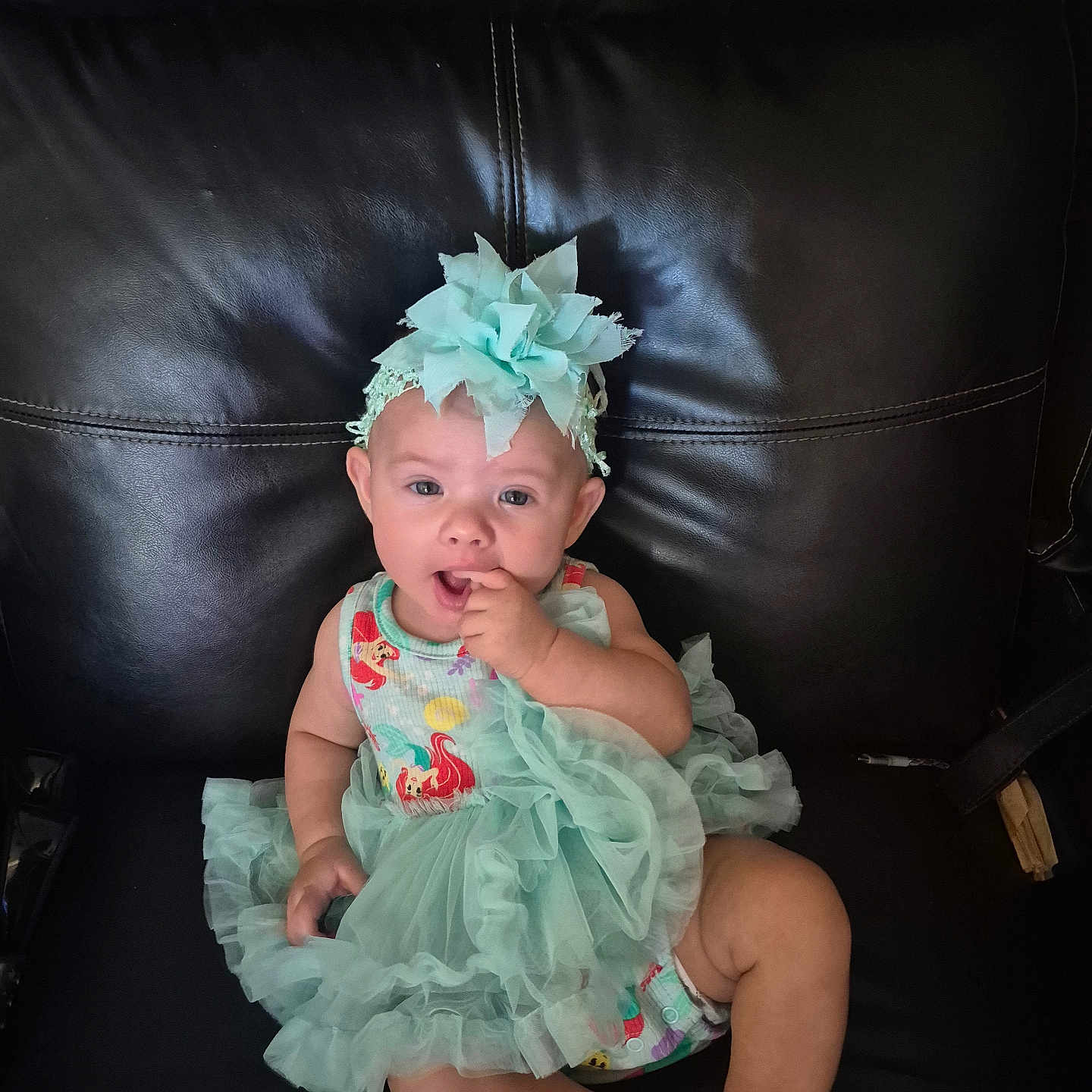 Serenity Norton is registered to the contest to win money with this photo: adorable, baby, child, clothing, couch, cute, dress, fashion, happy, headband, indoor, infant, leather, person, portrait, sitting, smiling, sock, toddler, young