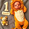 Leonard Thomas is registered to the contest to win money with this photo: baby, birthday, blanket, costume, cozy, eyes, face, headband, indoor, infant, lion_costume, milestone, mouse_toy, one_month, onesie, orange, photography, portrait, sleeping, stuffed_animal