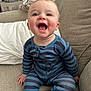 Oliver joined the competition — help win amazing prizes! baby, child, smiling, pajamas, striped_clothing, blue_clothing, couch, furniture, indoor, happy, face, eyes, mouth_open, sitting, home, cozy, infant, person, cute, cheerful