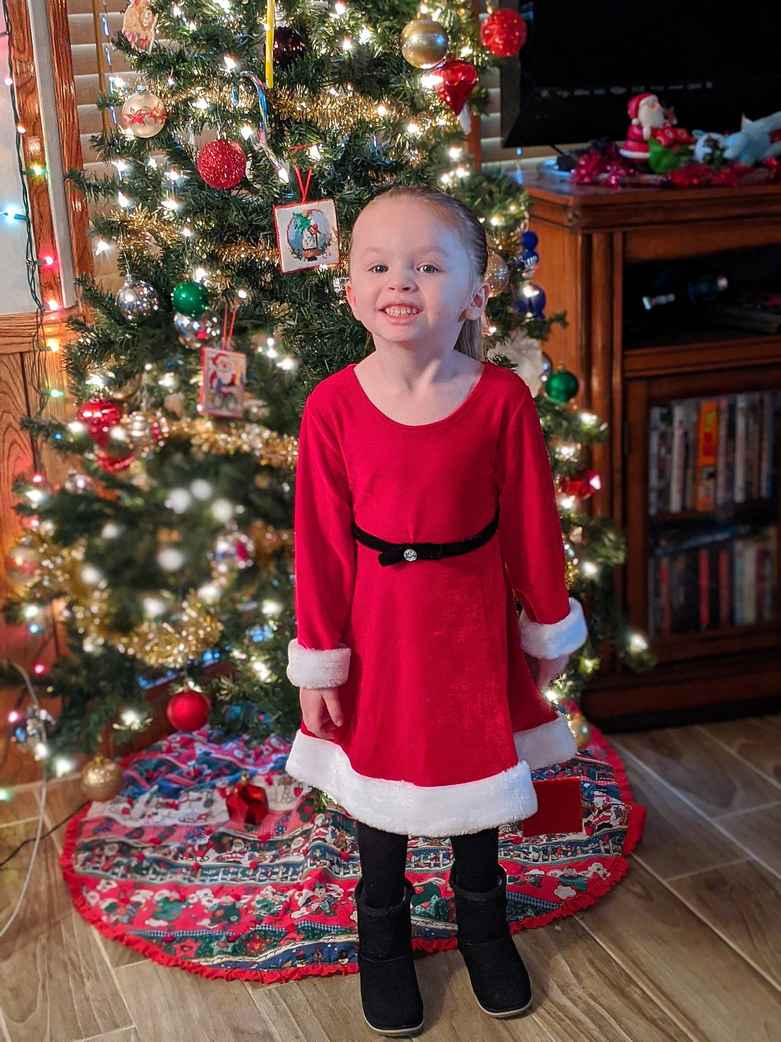 Averie joined the competition — help win amazing prizes! child, christmas, christmas_decoration, christmas_eve, christmas_ornament, christmas_tree, event, fictional_character, fir, holiday, holiday_ornament, interior_design, joy, outerwear, person, santa_claus, sitting, smile, standing, toddler