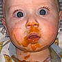 baby, messy_face, blue_eyes, puree, orange_sauce, bib, spilled_food, close_up, surprised_expression, drool, flash_photo, eyelashes, forehead, cheek, nose, mouth, hair, highchair_strap, baby_clothing, portrait