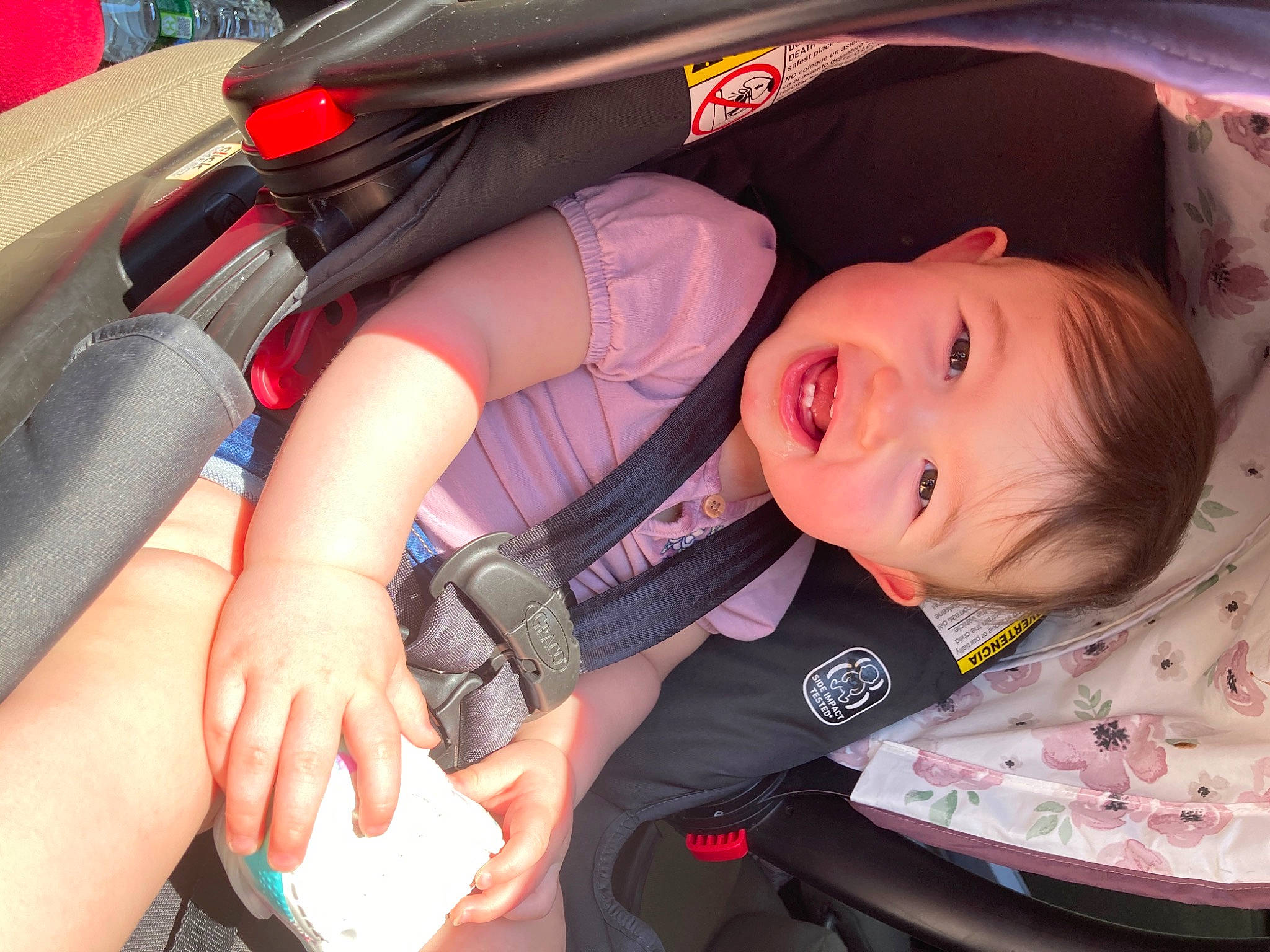 Alia is registered to the contest to win money with this photo: auto_part, baby, baby_carriage, baby_products, baby_safety, baby_toddler_clothing, car_seat, child, comfort, finger, gesture, hand, happy, person, product, red, skin, smile, thumb, toddler