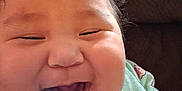 Kathleen Ann joined the competition — help win amazing prizes! baby, cheerful, child, close_up, clothing, couch, cozy, cupcake_pattern, cute, expression, face, happy, indoor, infant, joy, laughing, onesie, person, smiling, young_child