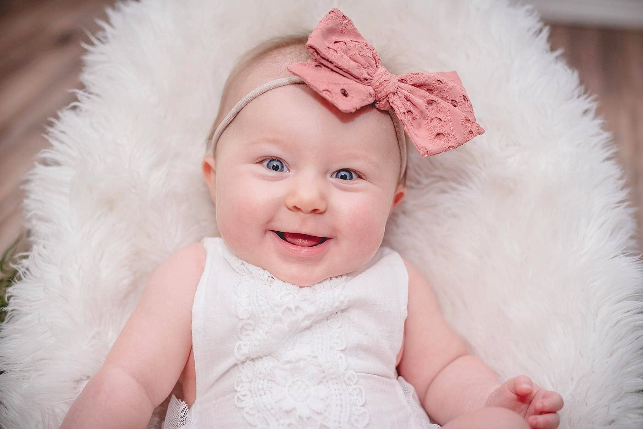 Karsyn is registered to the contest to win money with this photo: baby, cheek, child, child_model, dress, eye, face, fur, hair_accessory, head, headgear, headpiece, headwear, joy, lip, outerwear, person, photograph, photography, pink