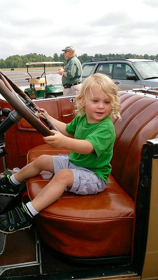 Bryce is registered to the contest to win money with this photo: automotive_design, blond, car, child, family_car, fun, girl, human_hair_color, land_vehicle, leg, luxury_vehicle, motor_vehicle, person, product, sitting, smile, vacation, vehicle