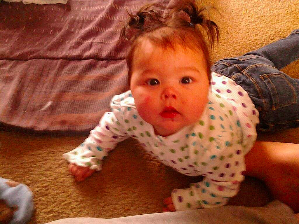 Kiyalyn is registered to the contest to win money with this photo: abdomen, baby, baby_toddler_clothing, barefoot, cheek, child, comfort, crawling, foot, linens, mouth, nightwear, nose, overall, person, skin, toddler, toe, tummy_time, wood_flooring