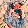 baby, infant, sleeping, pacifier, headband, bow, mittens, blue_dress, ruffles, blanket, floral, cute, newborn, soft, cozy, child, lying_down, adorable, peaceful, clothing