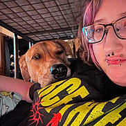 Lucifer joined the competition — help win amazing prizes! person, dog, indoor, selfie, glasses, piercing, purple_hair, bunk_bed, bedroom, facial_expression, resting, casual_clothing, black_tshirt, yellow_text, metal_frame, closeup, pet, companion, friendship, relaxing