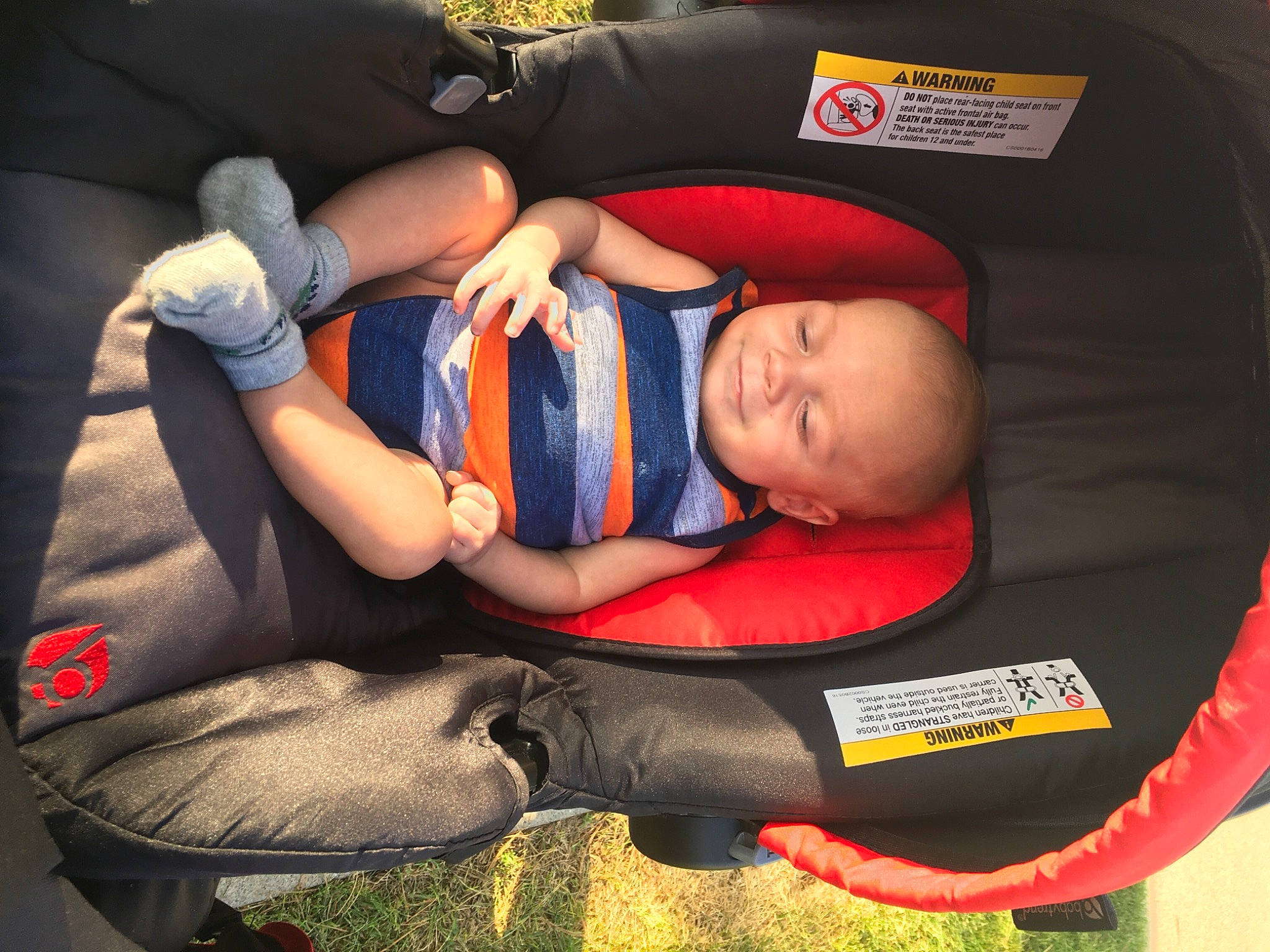 Kain joined the competition — help win amazing prizes! baby, baby_carriage, baby_products, baby_sleeping, baby_toddler_clothing, bag, car_seat, carmine, child, comfort, elbow, hat, human_leg, lap, orange, person, product, sitting, thigh, toddler
