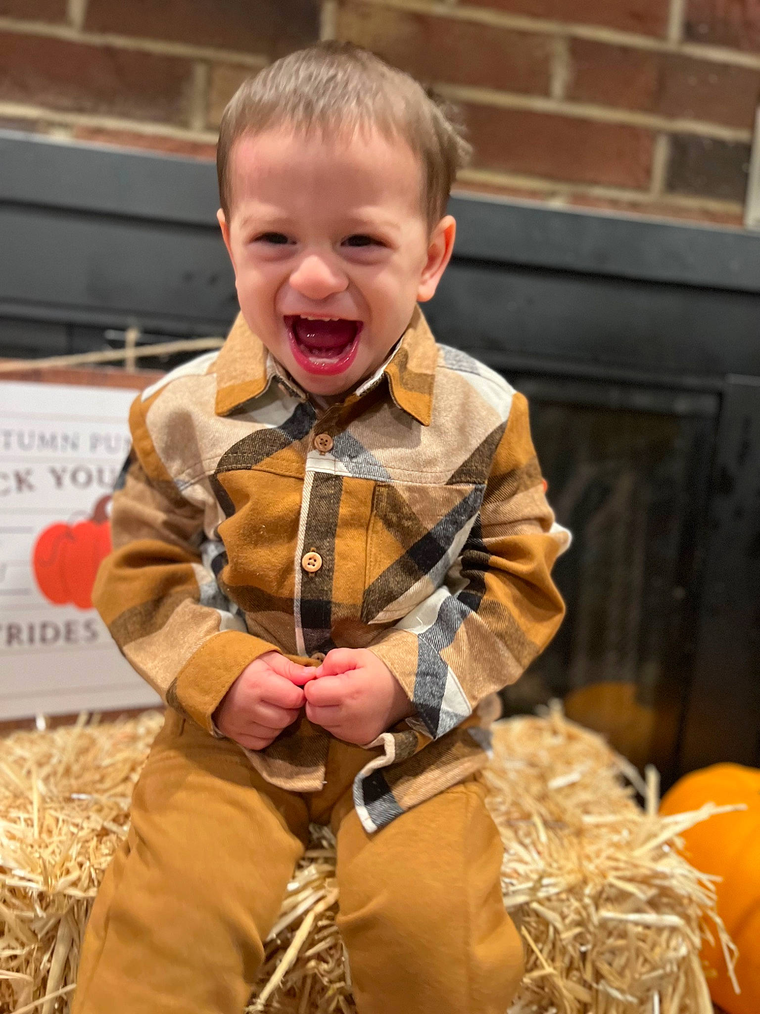 Jasiah joined the competition — help win amazing prizes! baby, belt, blond, child, clothing, fun, grass, happy, laugh, outerwear, pattern, person, personal_protective_equipment, sitting, sleeve, smile, soil, toddler, uniform, vacation