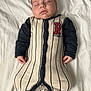Eli is registered to the contest to win money with this photo: baby, sleeping, onesie, striped_clothing, infant, bed, blanket, peaceful, child, indoor, soft_lighting, portrait, cute, resting, newborn, young_child, person, comfortable, clothing, head