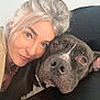 woman, dog, face, portrait, pet, snuggle, couch, indoor, silver_hair, black_dog, close_up, friendly, calm, relaxed, home, decor, love, companion, animal, cozy