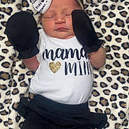 Cynsleigh is registered to the contest to win money with this photo: baby, black_pants, blanket, bow, clothing, cozy, cute, headband, infant, leopard_print, lying_down, mittens, newborn, peaceful, portrait, sleeping, small_hands, soft_texture, text_on_clothing, white_shirt