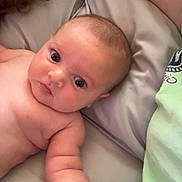 Tucker joined the competition — help win amazing prizes! arm, baby, bed, child, close_up, comfort, curly_hair, cute, expression, human, indoor, infant, lying_down, person, pillow, reaching_hand, skin, soft_fabric, tattoo, young