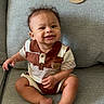 baby, child, smile, couch, indoor, plaque, wooden, eight_months, clothing, striped, happy, person, sitting, feet, hands, face, young, infant, portrait, home