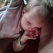 Freyja joined the competition — help win amazing prizes! child, baby, thumb_sucking, sleeping, cozy, blanket, soft_clothing, indoor, peaceful, cute, infant, resting, young_child, closeup, head, pale_skin, blond_hair, hand, portrait, relaxing