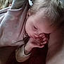 child, baby, thumb_sucking, sleeping, cozy, blanket, soft_clothing, indoor, peaceful, cute, infant, resting, young_child, closeup, head, pale_skin, blond_hair, hand, portrait, relaxing