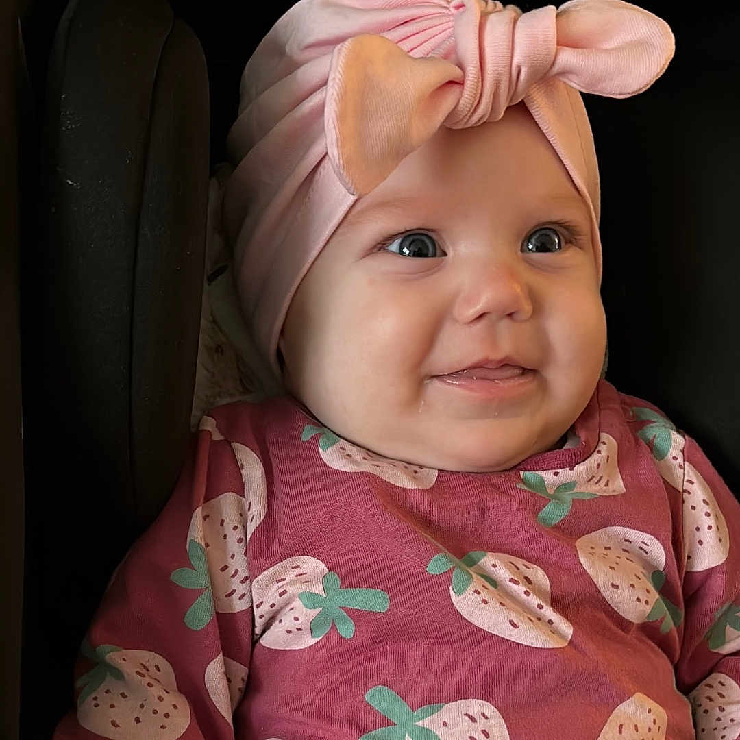 Selena Tessa joined the competition — help win amazing prizes! applique, baby, bodypart, bonnet, cap, clothing, couch, dress, face, finger, furniture, hand, happy, hat, head, newborn, person, photography, portrait, smile