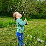 Gabriel participe au concours pour gagner de l'argent avec cette photo : child, boy, dandelion, grass, field, nature, outdoor, greenery, trees, plants, blowing, puff, casual_clothing, shoes, side_profile, standing, spring, daytime, young, curious