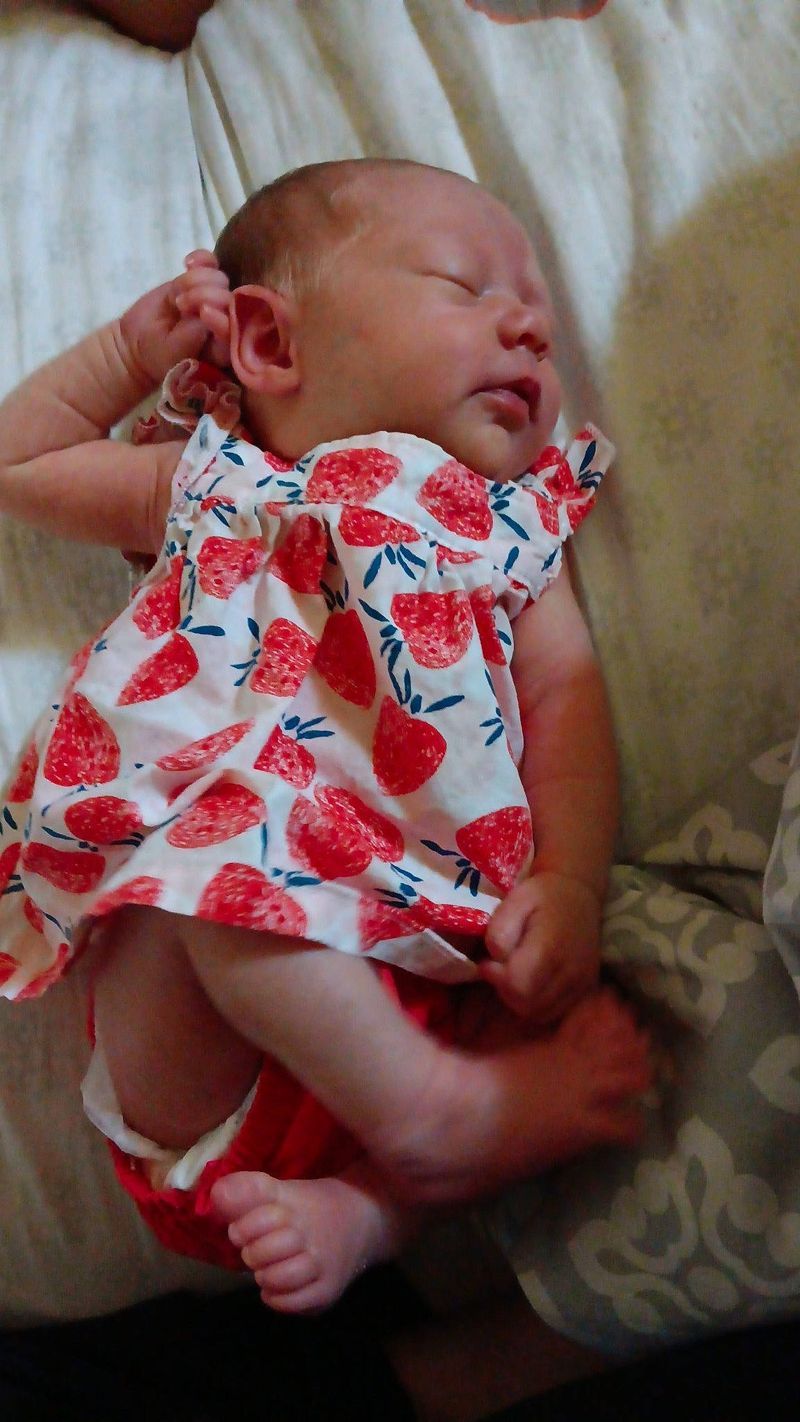 Jennifer is registered to the contest to win money with this photo: baby, baby_toddler_clothing, cheek, collar, comfort, dress, face, hand, happy, head, human_body, iris, lip, neck, organ, pattern, person, pink, skin, sleeve