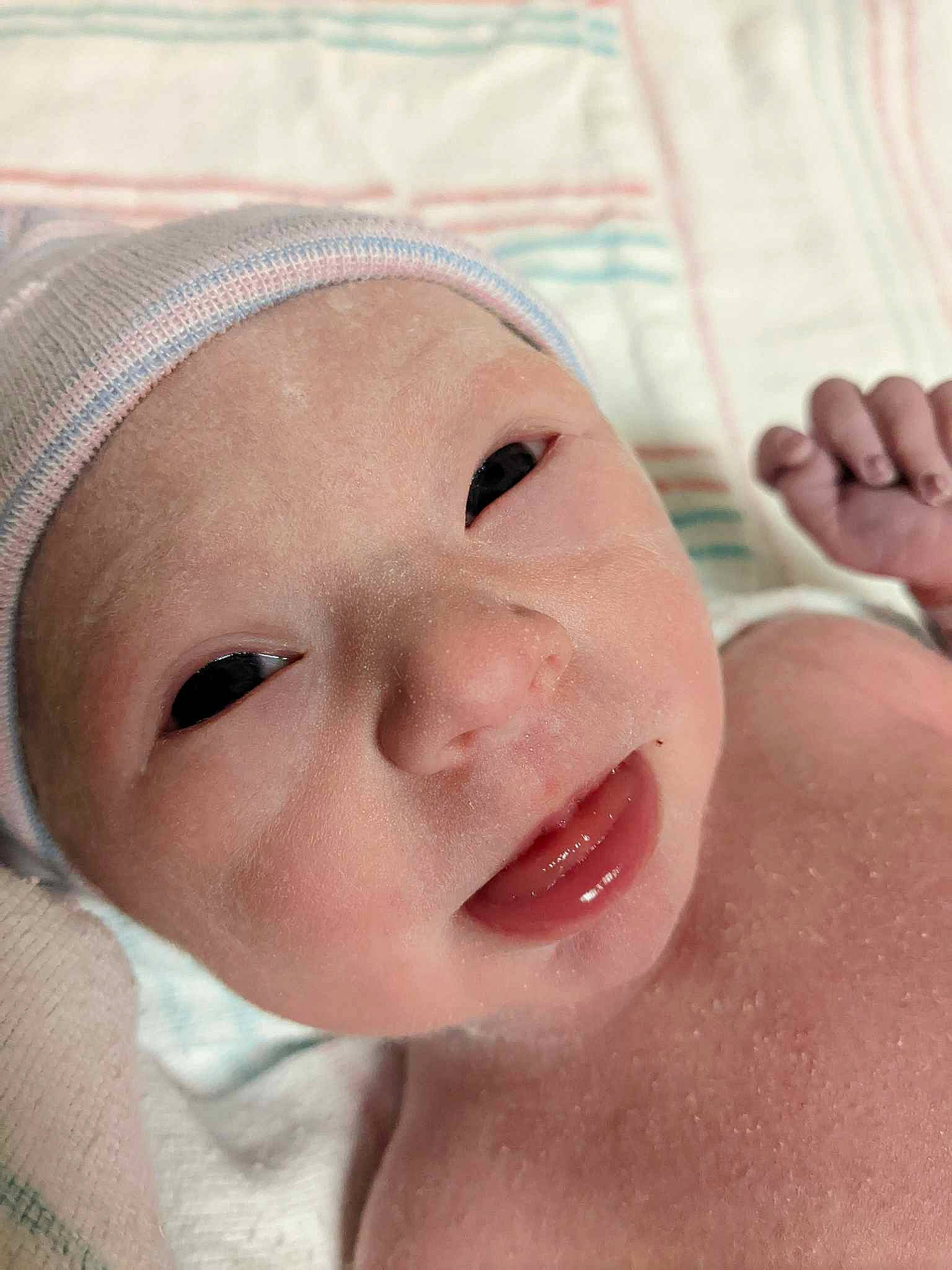 Jennifer joined the competition — help win amazing prizes! baby, cap, cheek, chin, ear, eye, eyebrow, eyelash, face, finger, gesture, happy, hat, headwear, human_body, jaw, lip, mouth, neck, nose