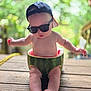 Cameron joined the competition — help win amazing prizes! baby, watermelon, sunglasses, cap, outdoor, wooden_deck, fruit, cute, summer, child, sitting, greenery, playful, sunny, fresh, funny, portrait, person, casual, relaxed