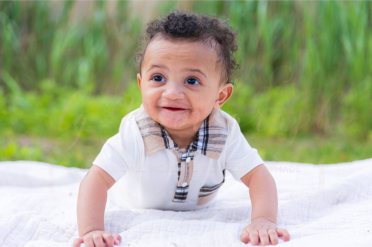 Josiah joined the competition — help win amazing prizes! baby, baby_toddler_clothing, child, comfort, crawling, eye, face, flash_photography, flooring, grass, happy, joy, leisure, people_in_nature, person, plant, sitting, skin, sleeve, smile