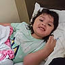 Amelia is registered to the contest to win money with this photo: child, smile, bed, blanket, pillow, shirt, hair, indoor, portrait, happy, person, face, relax, cozy, casual, rest, young, cute, comfort, sleepwear