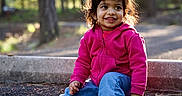 Nidhira Avirneni is registered to the contest to win money with this photo: blue_jeans, casual_clothing, child, cute, daylight, fluffy_slippers, forest, ground, happy, nature, outdoor, pine_needles, pink_hoodie, playful, portrait, sitting, smiling, sunlight, toddler, young_child