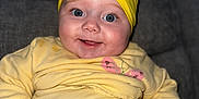 Kyla joined the competition — help win amazing prizes! baby, child, smiling, yellow_clothing, headband, bow, blue_eyes, couch, indoor, portrait, happy, infant, closeup, soft_fabric, sitting, cute, person, cozy, comfortable, casual_wear
