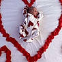 Kyla is registered to the contest to win money with this photo: newborn, baby, sleeping, heart_shape, rose_petals, white_sheet, red_hearts, onesie, cute, infant, peaceful, lying_down, soft_texture, love, adorable, small_baby, portrait, baby_clothes, indoor, closeup