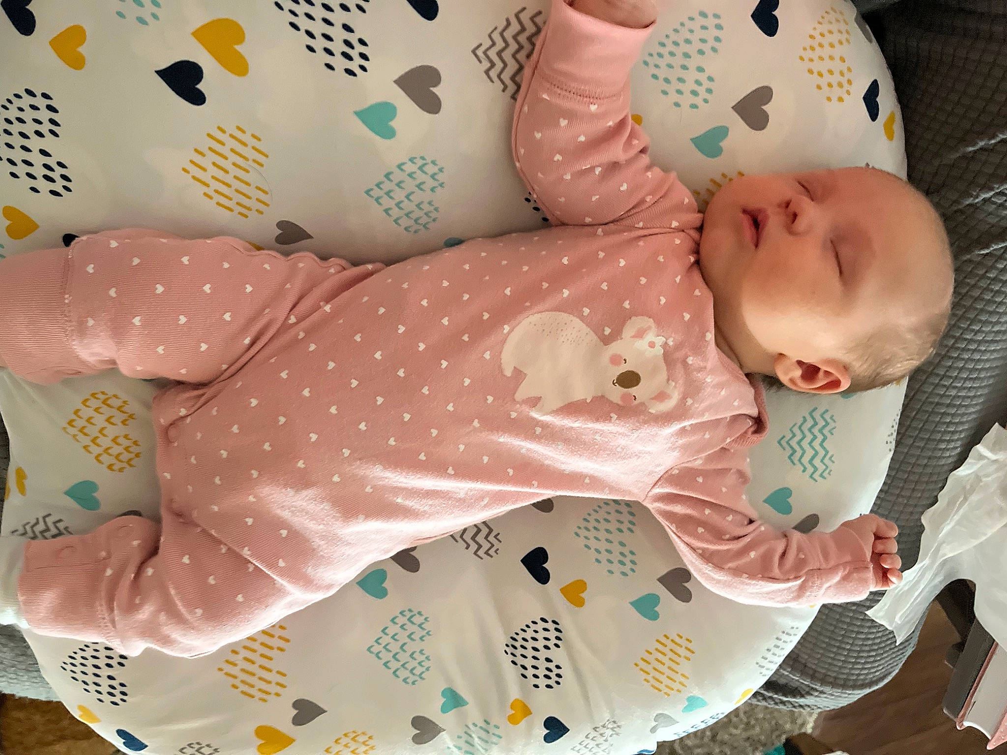 Serena is registered to the contest to win money with this photo: arm, baby, baby_products, baby_sleeping, baby_toddler_clothing, bedding, child, comfort, infant_bodysuit, linens, pattern, person, pink, polka_dot, product, room, sleeve, textile, thigh, toddler