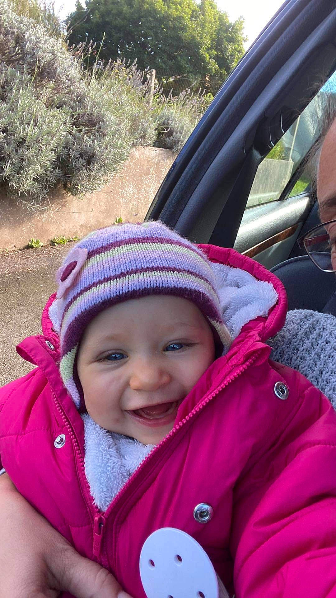 Lyah a rejoint le concours — aidez-le/la à gagner de superbes lots ! baby, baby_products, cap, child, fun, grass, happy, headwear, jacket, leisure, magenta, person, photograph, pink, plant, product, recreation, smile, steering_wheel, toddler