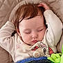 baby, sleeping, infant, pacifier, blanket, plush_toy, onesie, cartoon_character, face, head, closed_eyes, hand, hair, soft_lighting, cozy, cute, indoor, resting, child, peaceful